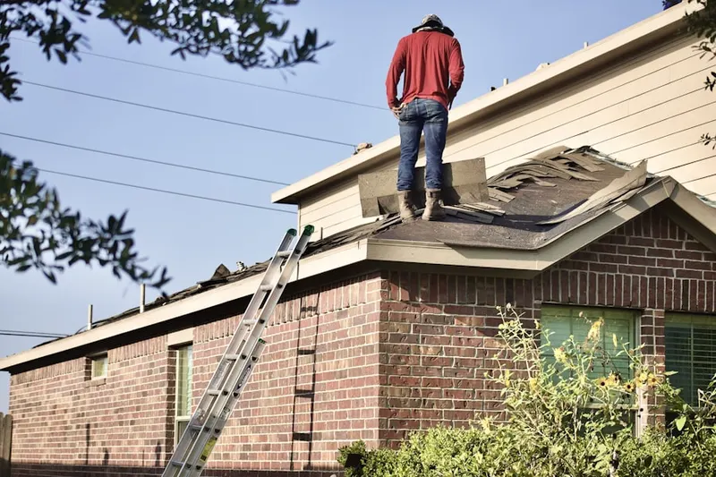Professional roofer working on a residential roof in Eagle Bay